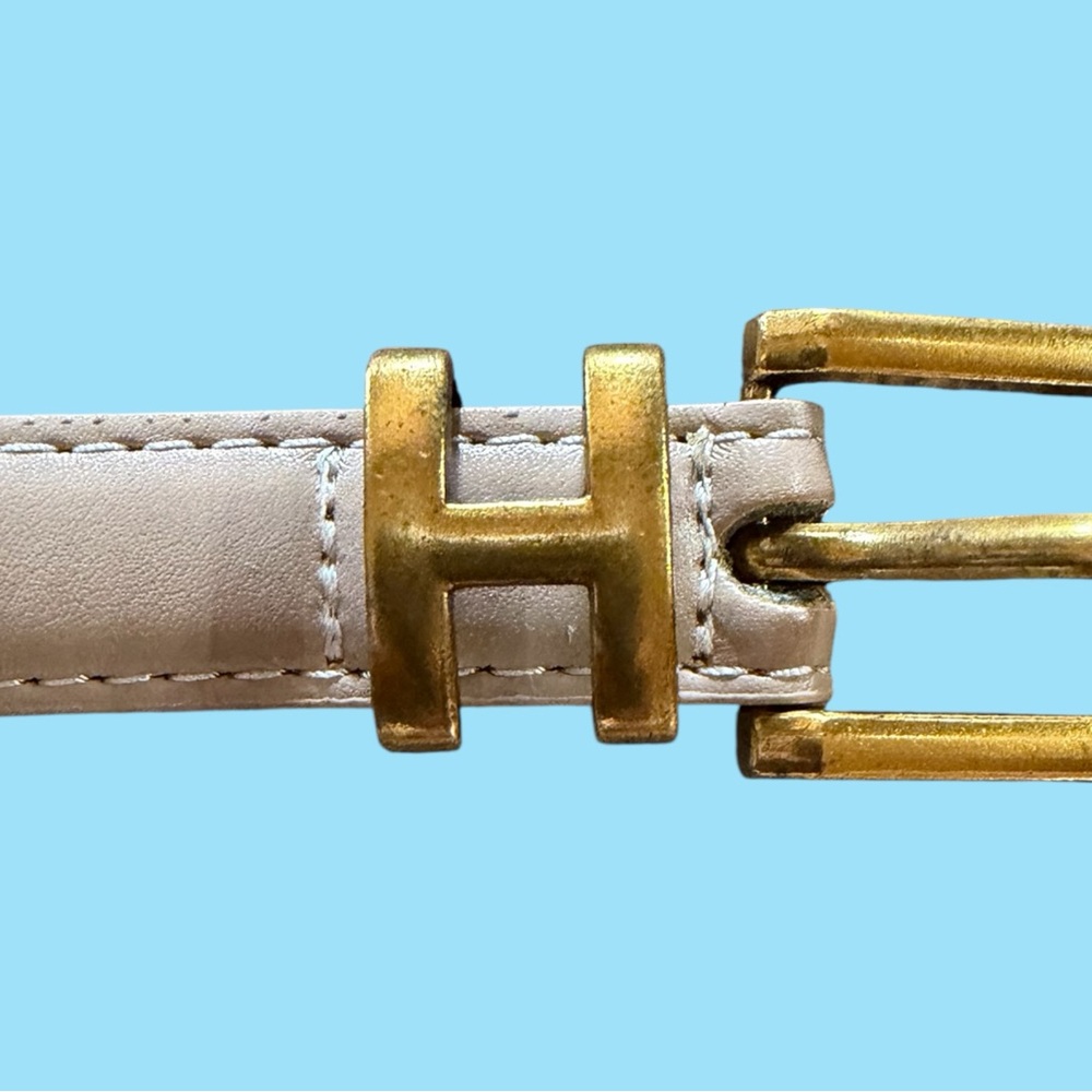 New w/o tags. Gold Buckle in a letter H. Beige Belt. 37” long.